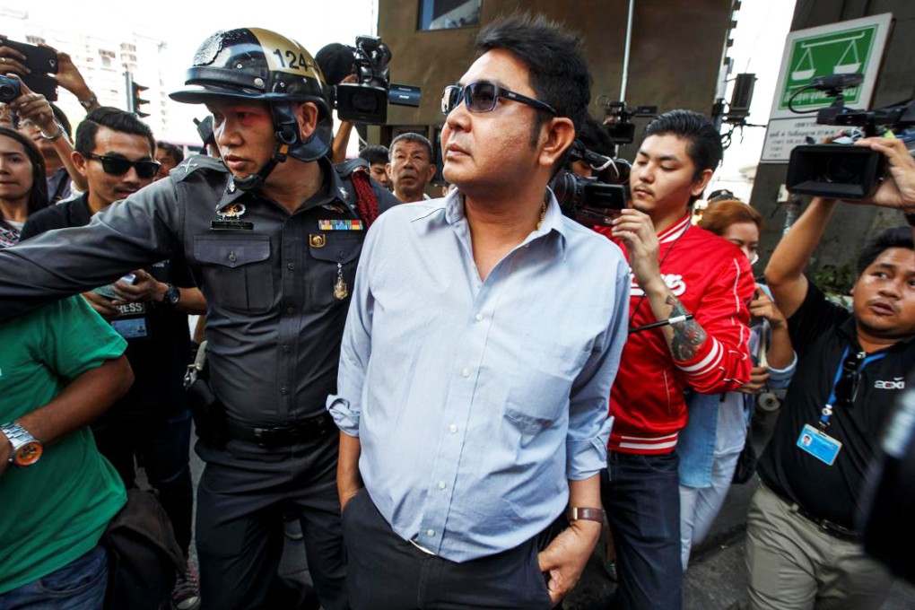 Thai pro-democracy protester Akkarakit Noonchan (centre) is detained by police near Victory Monument in Bangkok yesterday. Photo: Reuters