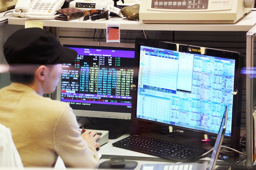 Traders monitor share prices at One and Two Exchange Square in Central. Photo: Felix Wong