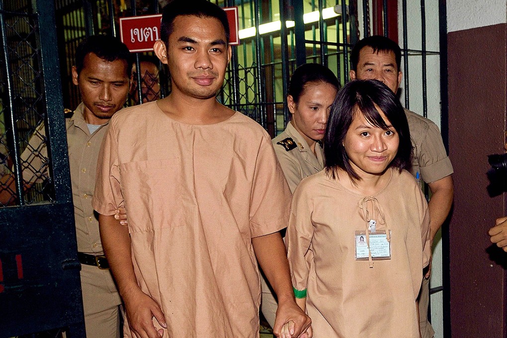 Thai student Patiwat Saraiyaem (left), 23, and activist Porntip Mankong, 26, are escorted by prison security guards after the verdict on Monday. Photo: AFP