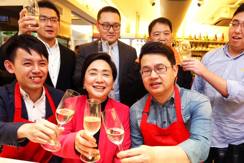 Democratic Party leaders (front row from left) Lo Kin-hei, Emily Lau and Andrew Wan raise a glass to their party. Photo: Felix Wong