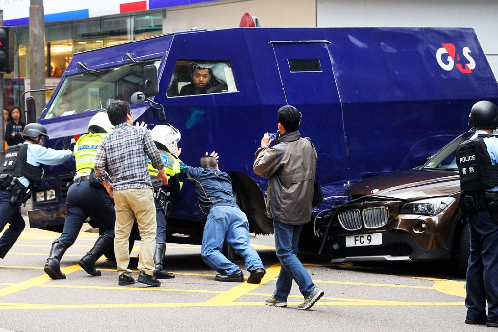 Another blunder: a G4S security van sits upon a crushed BMW following a collision on Hong Kong's Des Voeux Road. Photo: SCMP
