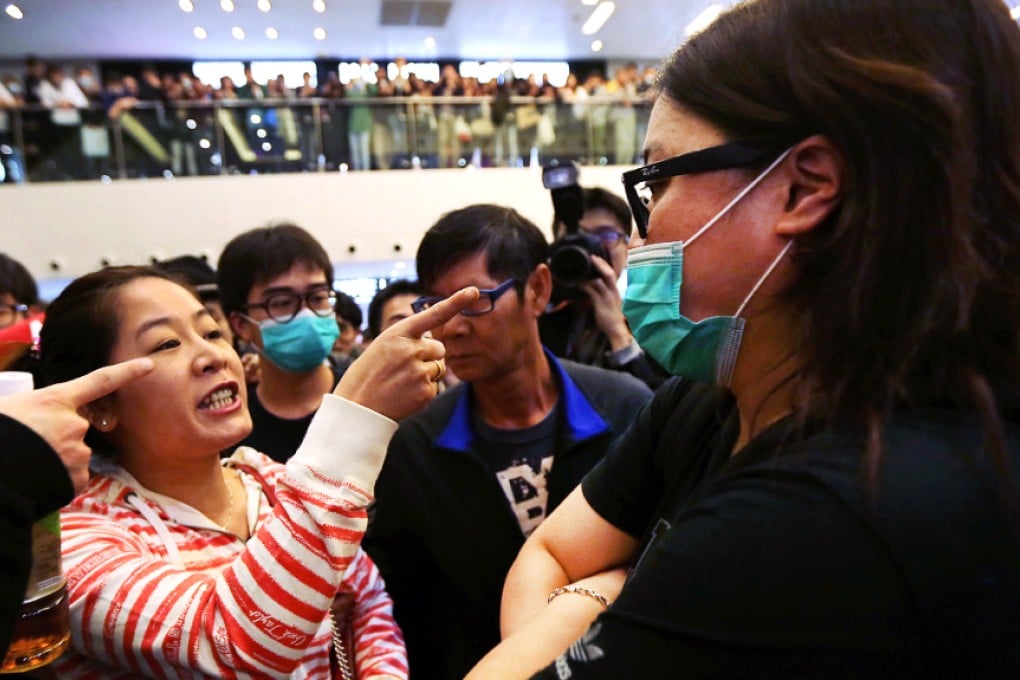 Protesters clash with travellers during a rally against parallel trading at New Town Plaza in Shatin on February 15, 2015. Analysts say the recent spate of protests against mainland visitors in the city has prompted them to travel elsewhere. Photo: Felix Wong