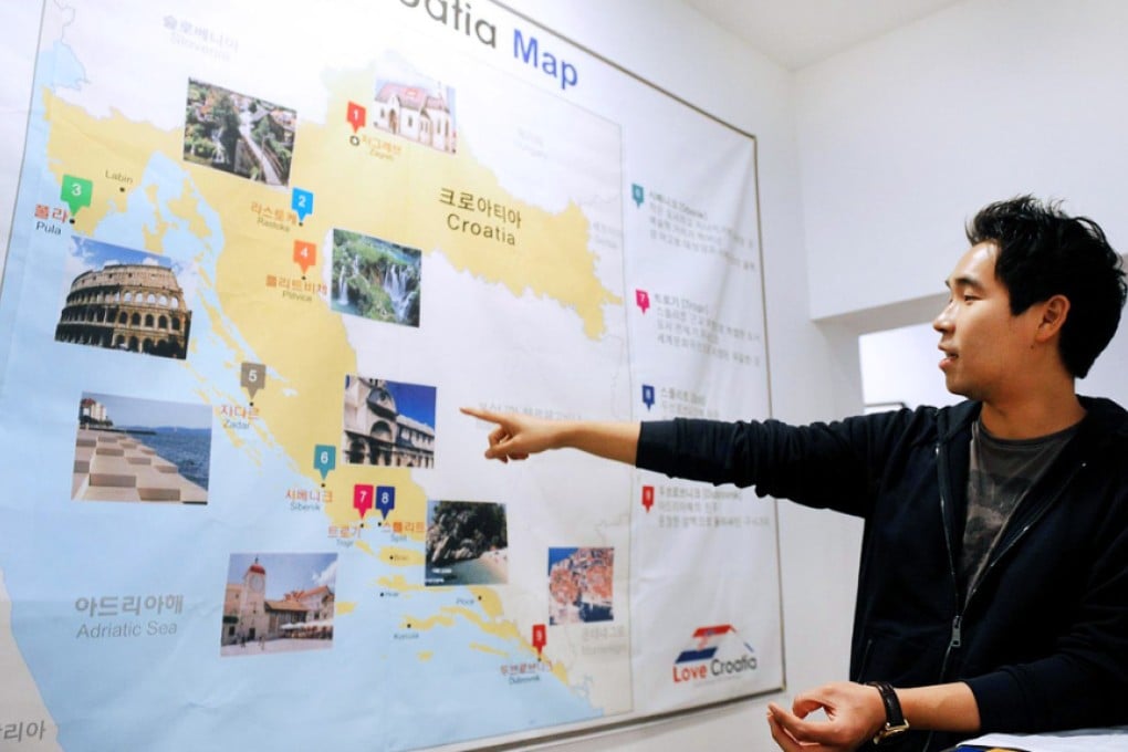 Hostel owner Kim Seoung-hoon points out the highlights. Photo: AFP