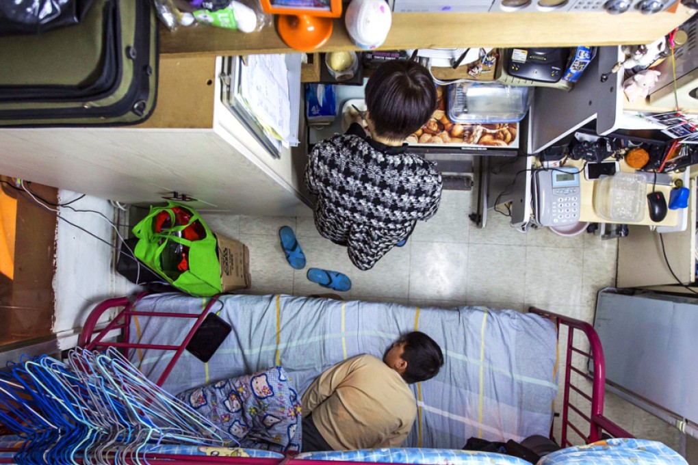 A woman and her son are seen in their 60-square-foot sub-divided flat, with a monthly rent of HK$3,800 (US$487), in Hong Kong. Photo: Reuters