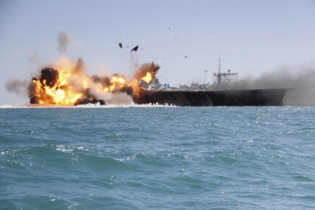 Revolutionary Guard fighters blow up a vessel designed to resemble a US Navy carrier near the Strait of Hormuz during the drill named 'Great Prophet 9'.Photo: AP