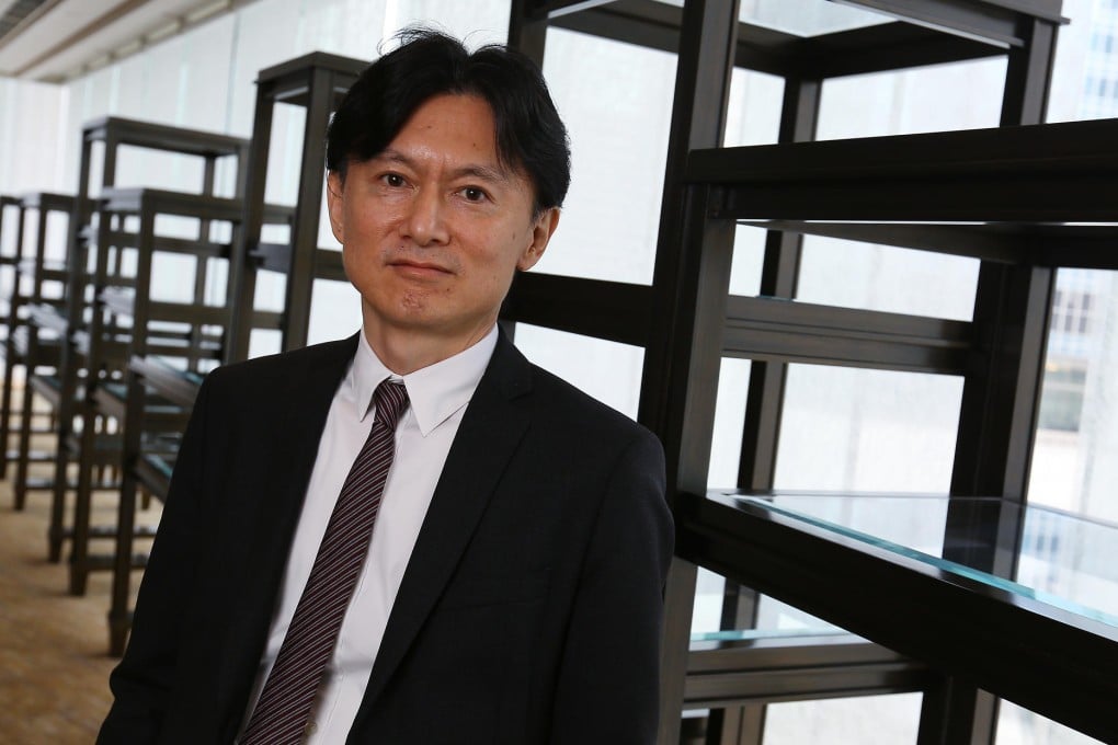 Fast Retailing chief financial officer Takeshi Okazaki says the firm wants to become the world's largest retailer in five years. Photo: Edmond So