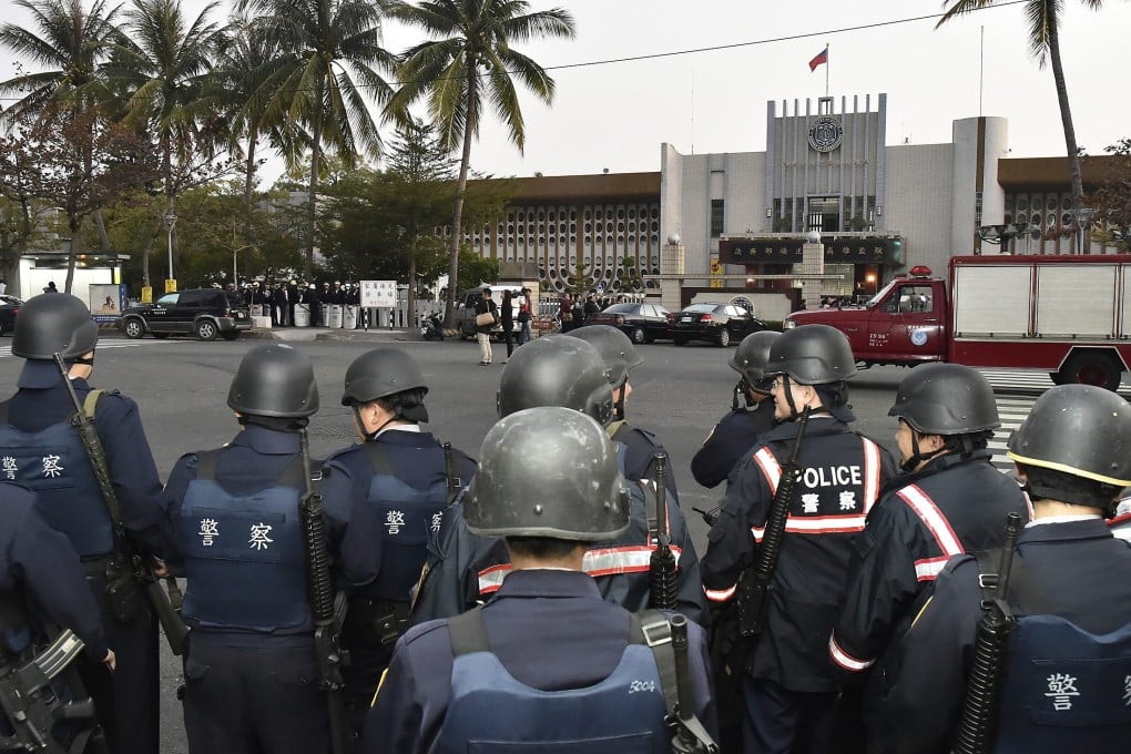 Armed police stand guard outside Kaohsiung Prison, in southern Taiwan, during the siege on February 11. Photo: Reuters