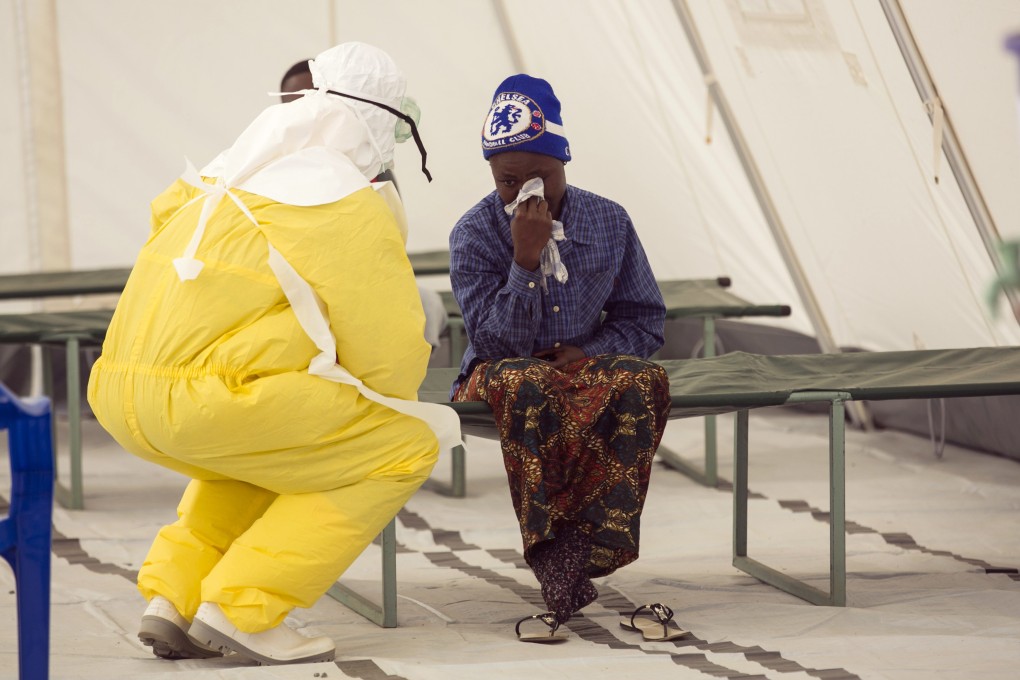 A health worker tends to a suspected Ebola patient in a quarantine zone at a Red Cross facility in the town of Koidu in Sierra Leone in December. Photo: Reuters