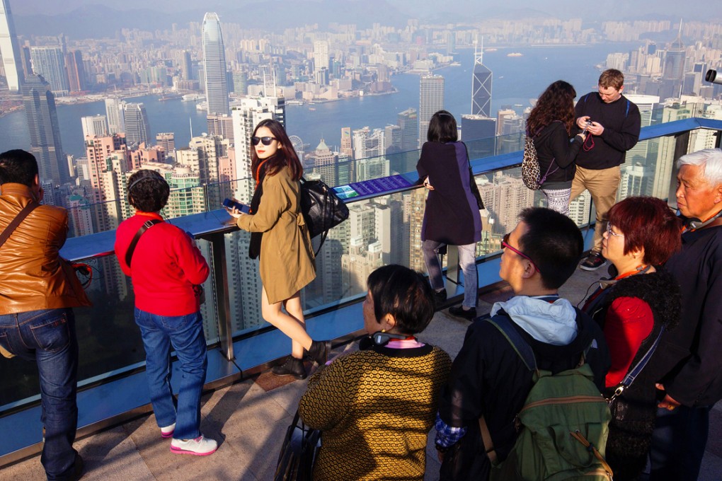 Tourists enjoy the views from The Peak. Over the Lunar New Year holidays, the number of mainland Chinese visitors to Hong Kong dropped 1 per cent year on year to 842,124. Photo: EPA