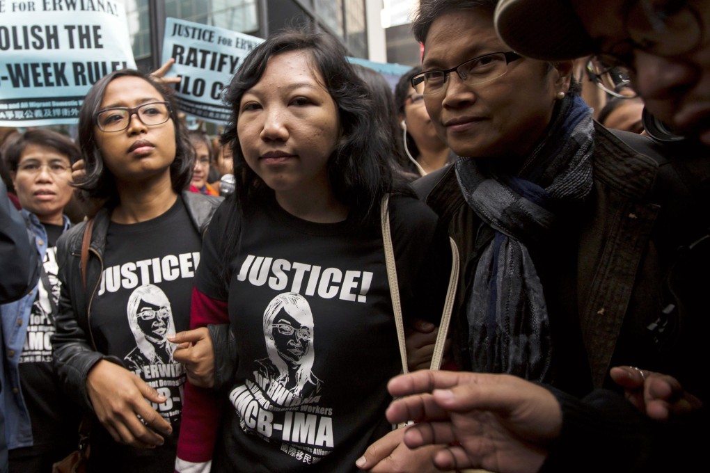 Erwiana Sulistyaningsih, centre, with supporters outside the District Court in Wan Chai yesterday. Photo: Reuters