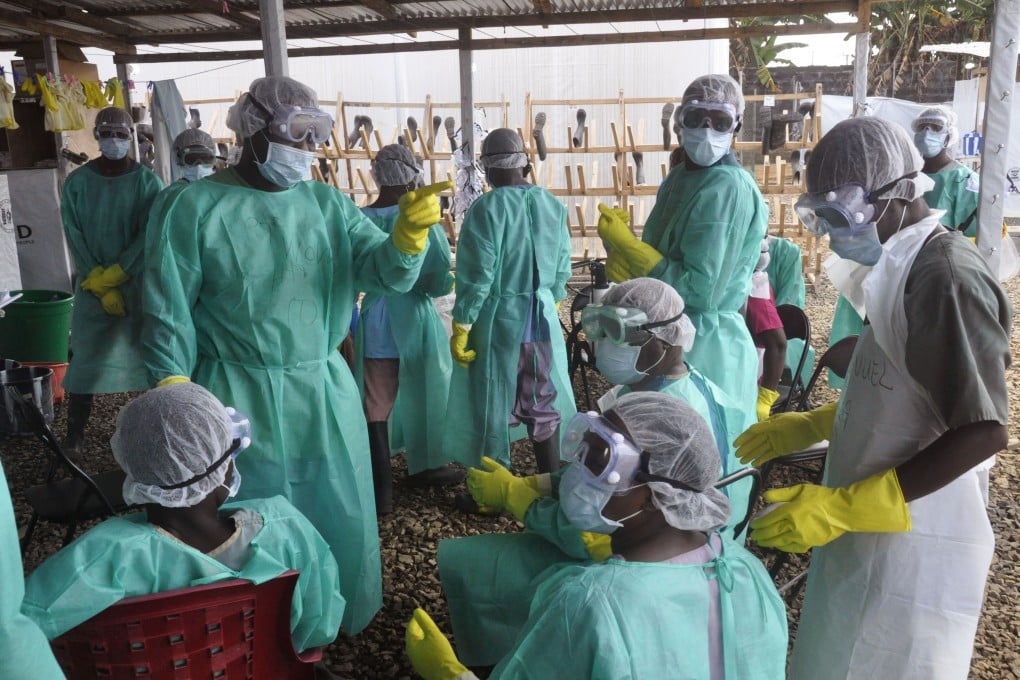 Health workers prepare for work at an ebola clinic in Monrovia, Liberia. Photo: AP