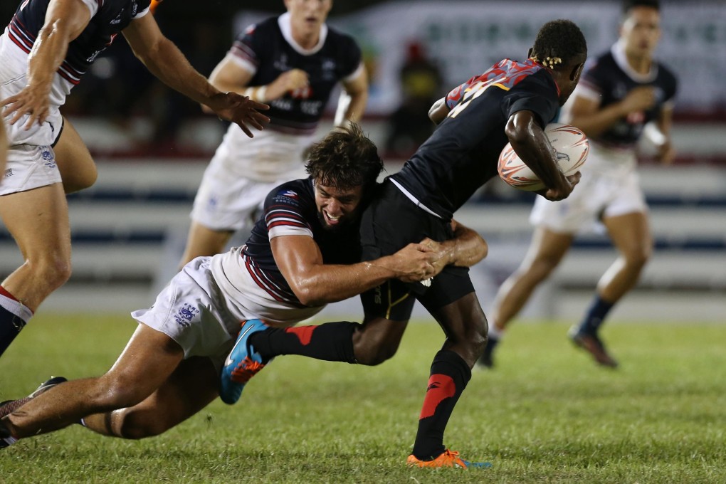 Chris Maize stifles a Papua New Guinea attack on day two of the Borneo Sevens. Photos: HKRFU