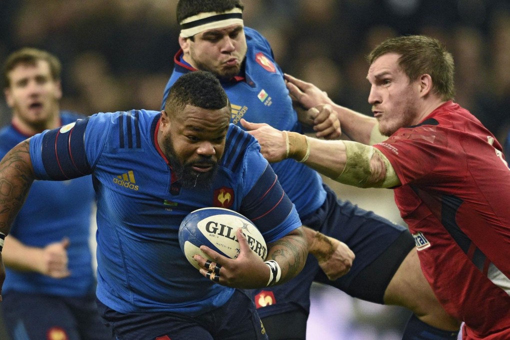 Burly France centre Mathieu Bastareaud brushes off Wales' Gethin Jenkins in their Six Nations match in Paris. Wales won 20-13. Photo: AFP