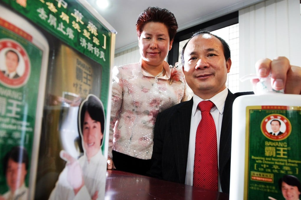 BaWang Chairman Chen Qiyuan (right) and CEO Eva Wan pose with their products, which used movie star Jackie Chan to promote. Photo: Sam Tsang