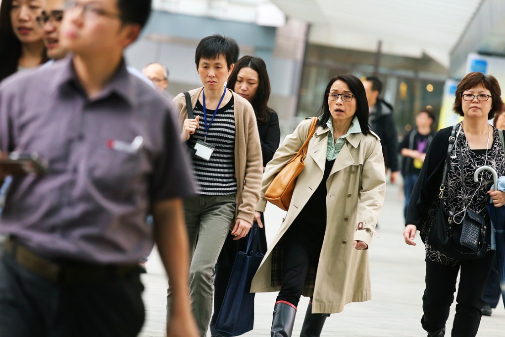 Government functionaries walk out from the Central Government offices at Tamar. Photo: K.Y. Cheng