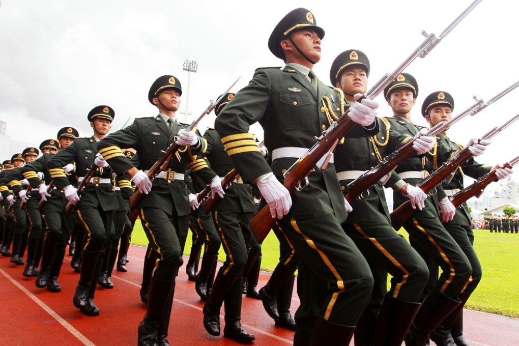 A file photo taken on July 1, 2014 shows PLA soldiers marching at PLA Hong Kong Garrison Stonecutters Island Barracks. The massive crackdown indicated Xi was willing to step in to eradicate the legacy of disgraced top officials. Photo: Edward Wong