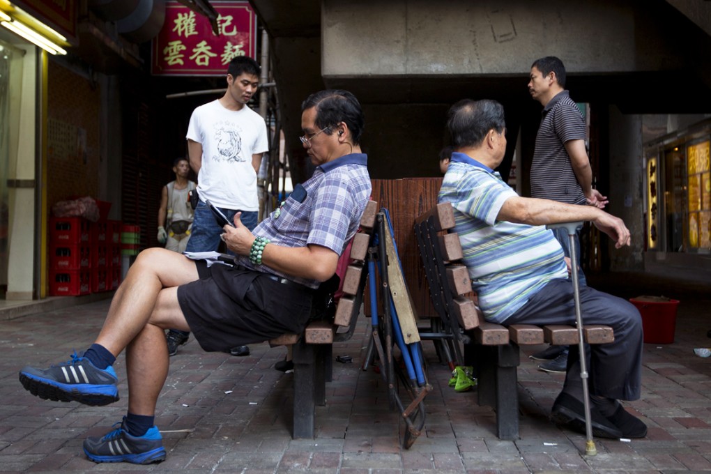 Men sit on a bench in North Point. The fund will be set up this year to cope with structural deficits likely to emerge within a decade amid an ageing population and a shrinking workforce. Photo: Bloomberg