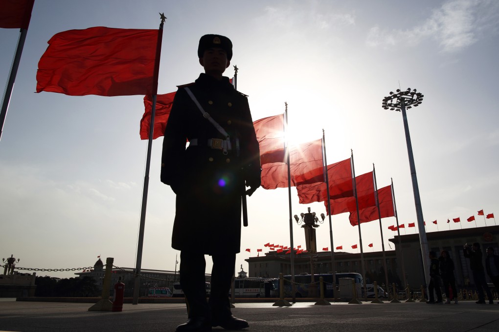 A paramilitary policeman on guard near the Great Hall of the People ahead of this week's parliamentary meetings in Beijing. Photo: Bloomberg