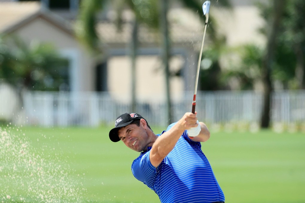 Irishman Padraig Harrington plays his shot out of a fairway bunker on the 18th hole of the fourth round. Photos: AFP