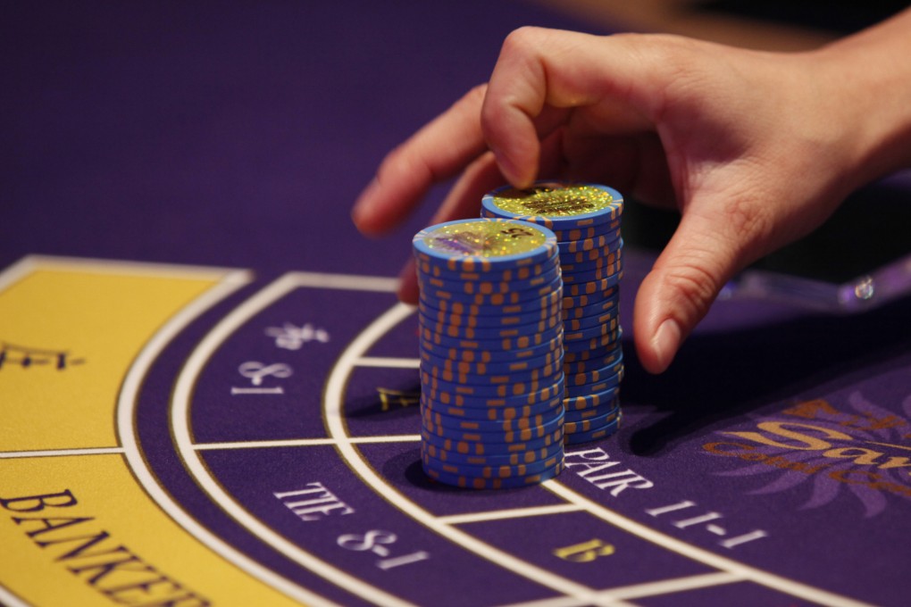 A croupier counts chips at a baccarat table in Macau. Photo: AP