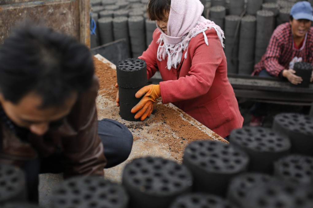 Workers load coal at a coal processing plant in Hebei. Photo: AP