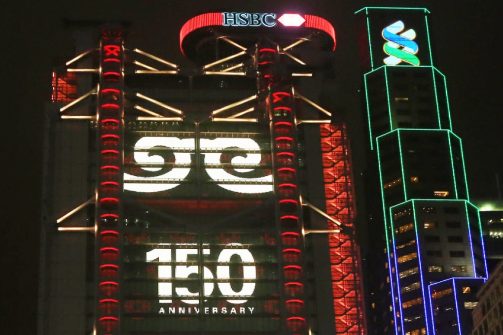 The impressive 150th anniversary light show illuminates HSBC headquarters in Central. Photo: Nora Tam