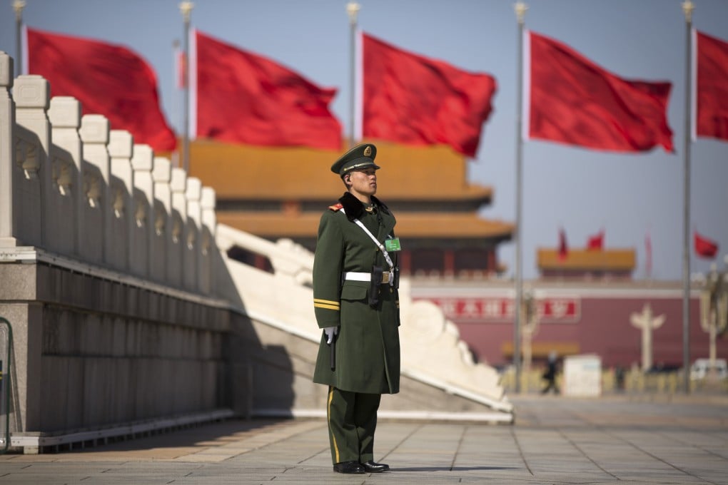 A paramilitary police officer stands guard in Tiananmen Square near the Great Hall of the People. The National People's Congress formally opens on Thursday. Photo: Associated Press