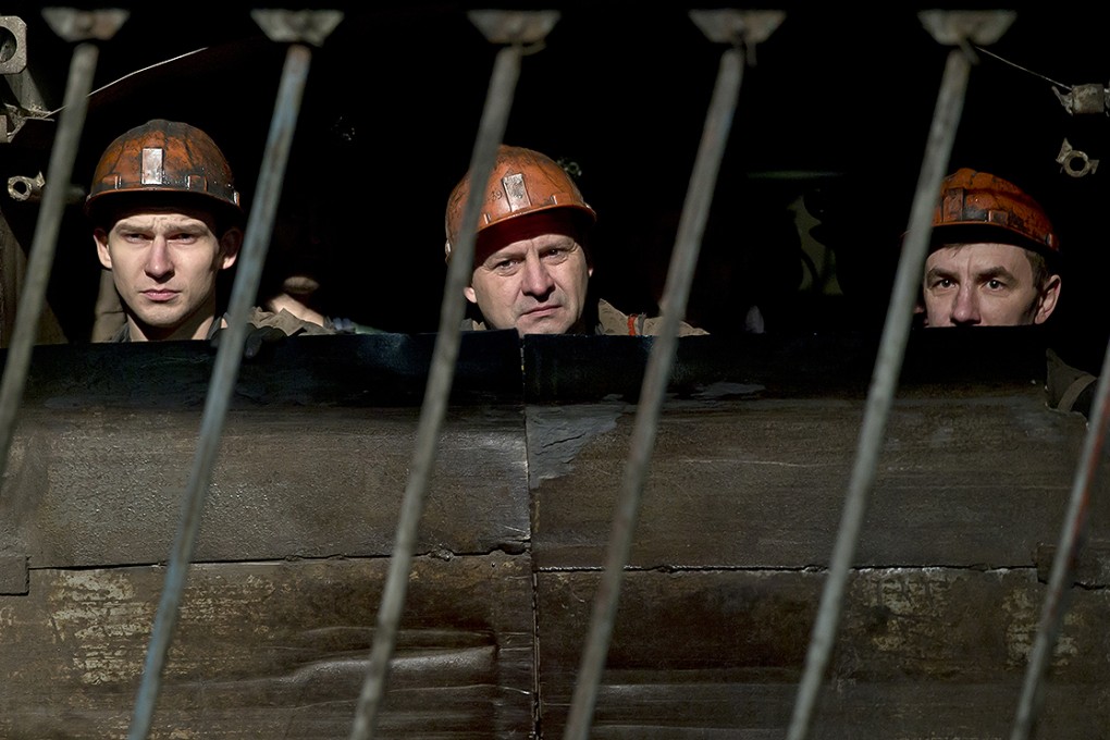 Miners start their descent underground at the Zasyadko mine to search for survivors. Photo: Reuters