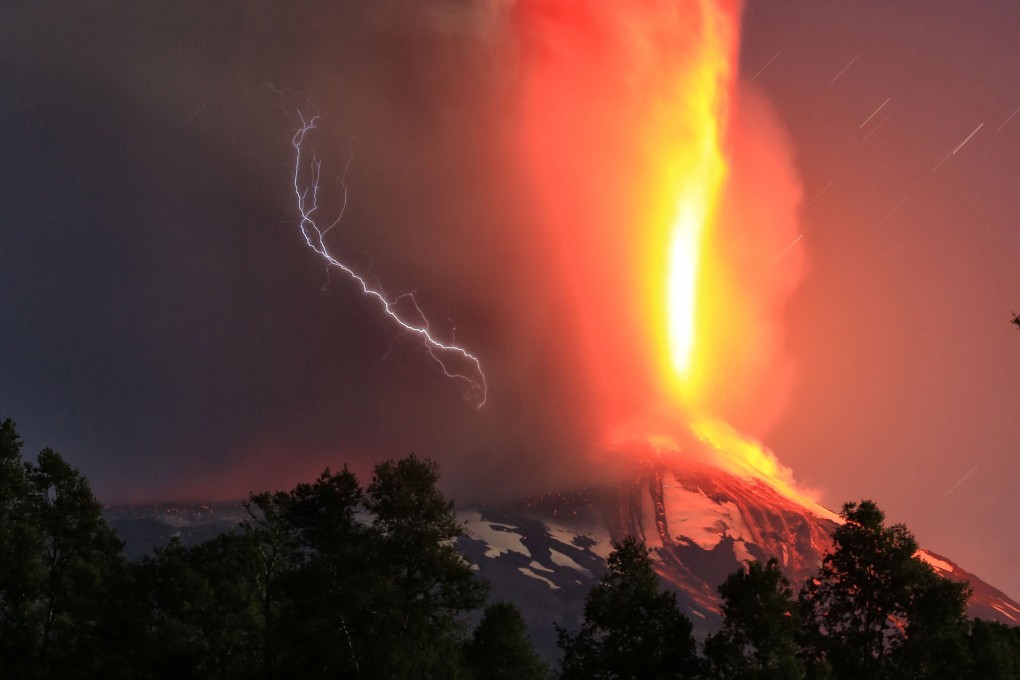 Lightning and a huge geyser of lava light up the sky over the Villarrica volcano on Tuesday. Photo: AFP