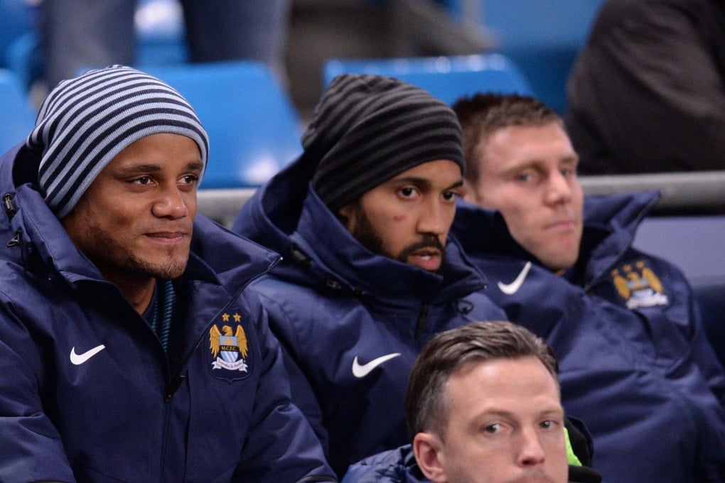 Manchester City defender Vincent Kompany looks on from the bench. Photo: AFP