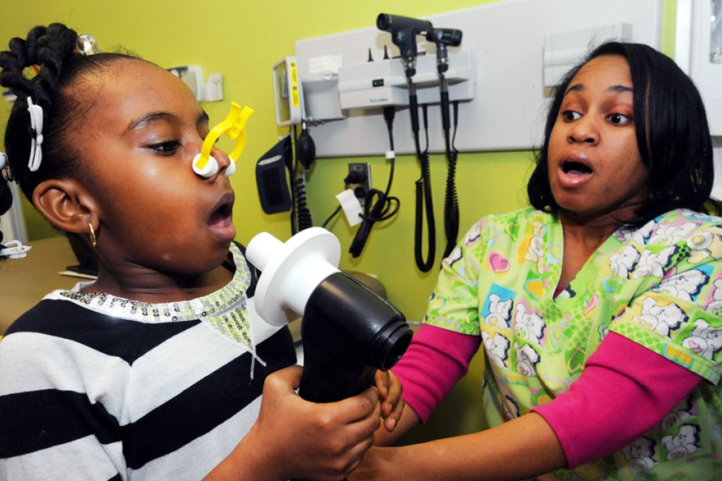 A girl takes a breathing test at the Johns Hopkins Children's Center in Baltimore, Md. Photo: TNS