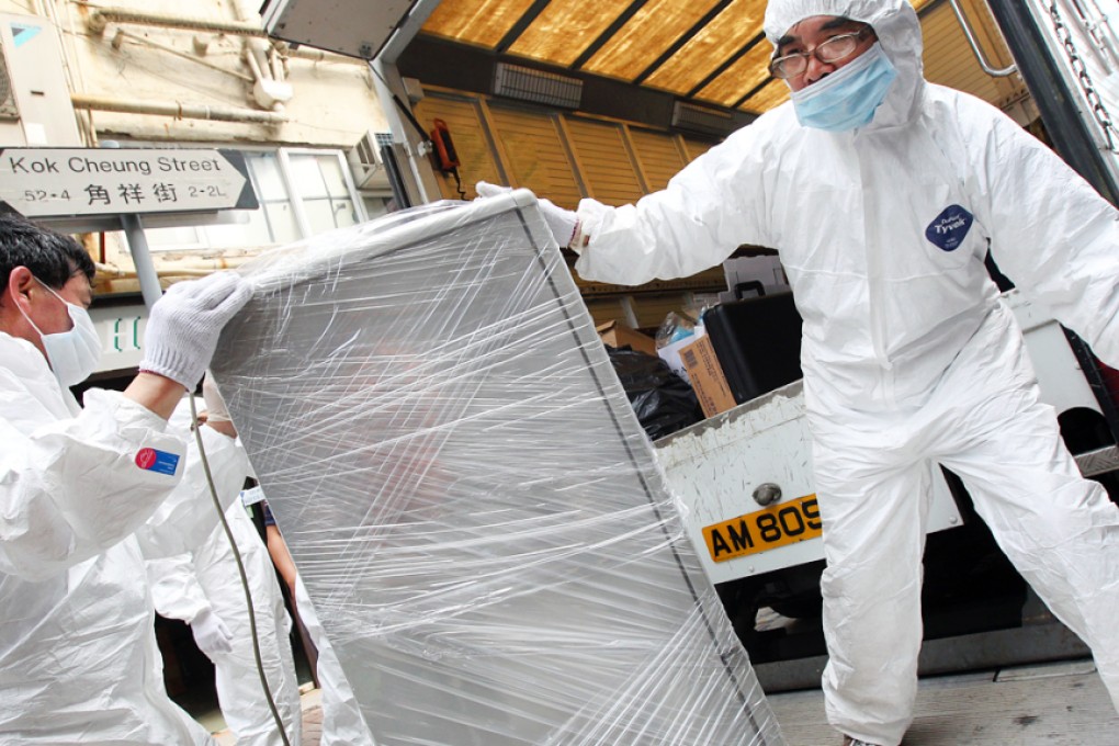 Police takes away a refrigerator  from Hoi Hing Building in Tai Kok Tsui in 2013 which is believed to store the bodies of a pair of couples. Photo: David Wong