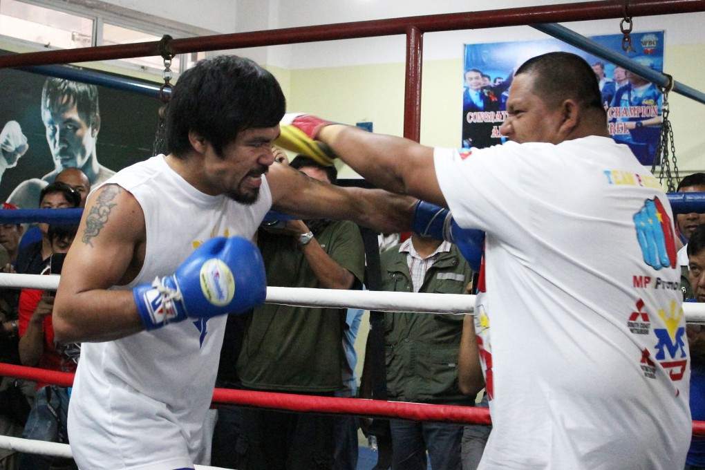 Pacquiao hits mobile punching bag Buboy Fernandez in training last month. Photo: AP