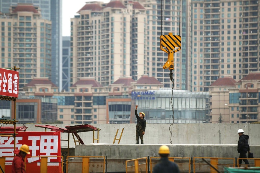 Labourers work at a construction site in Shanghai. Chinese Premier Li Keqiang warned this week of the need for China to diversify its economy away from traditional industry. Photo: Reuters