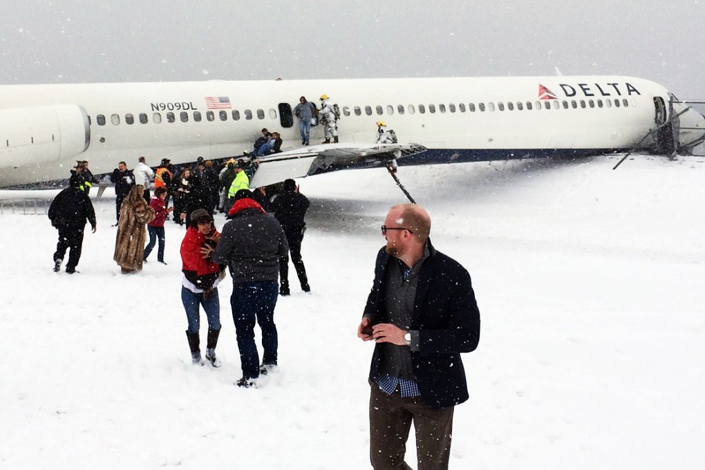 Passengers walk away from Delta Flight 1086 on Thursday. Photo: The Washington Post