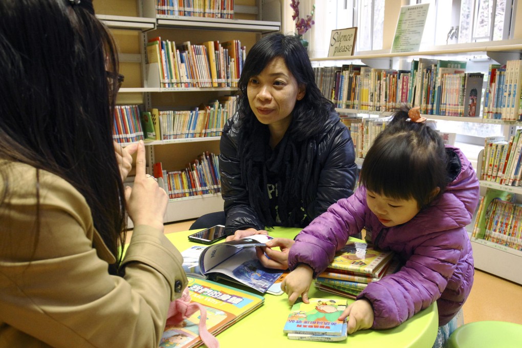 Social worker Winnie Ng (centre) working with one of the young mothers. Photos: Jonathan Wong, Dickson Lee