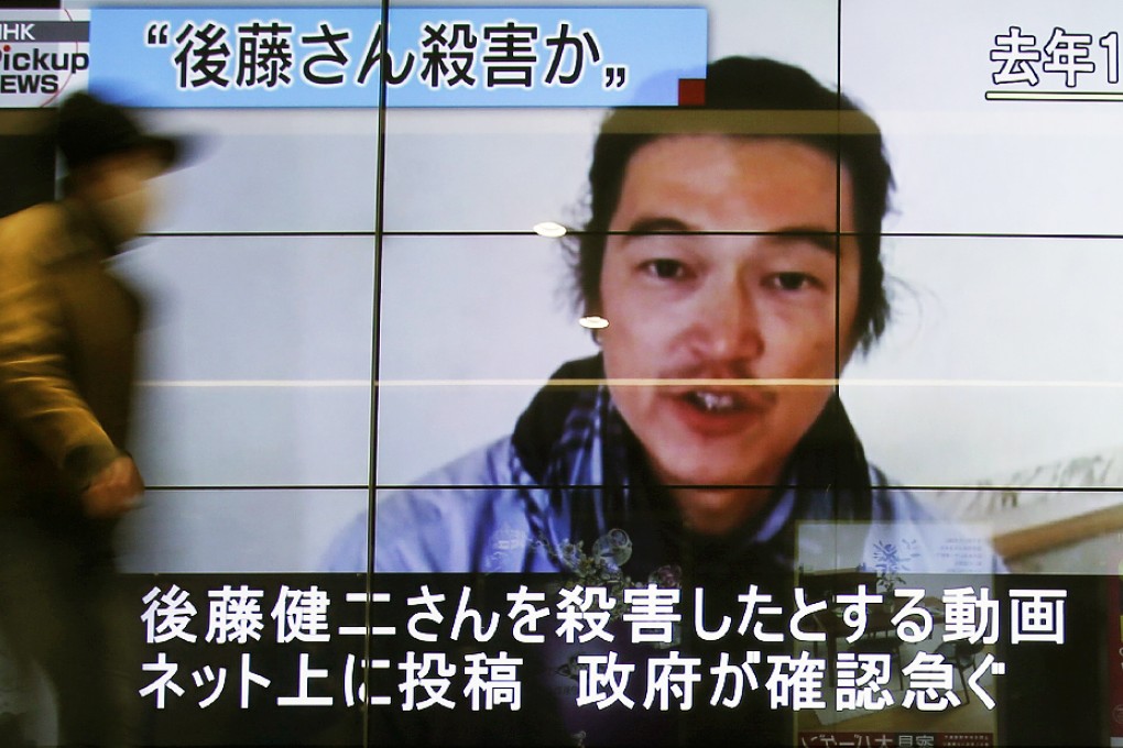 The beheading of Islamic State hostage Kenji Goto, seen here on a television screen in Tokyo, shocked Japan and may have shifted attitudes to military action overseas. Photo: Reuters