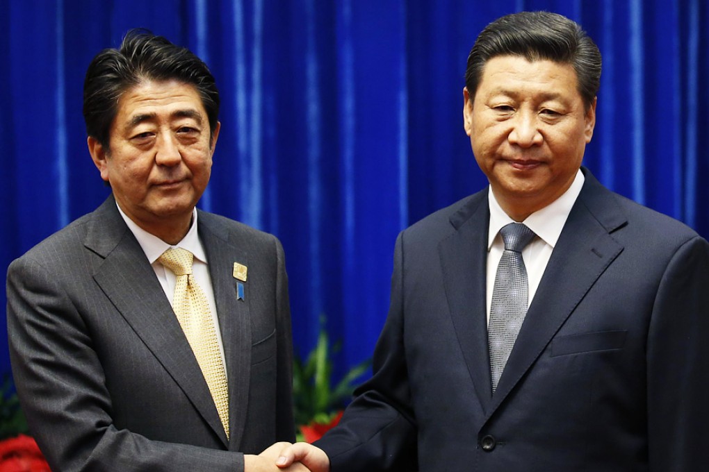 Ties between the nations improved slightly after President Xi Jinping (right) met Japanese Prime Minister Shinzo Abe on the sidelines of the APEC meeting in Beijing last November. Photo: Reuters