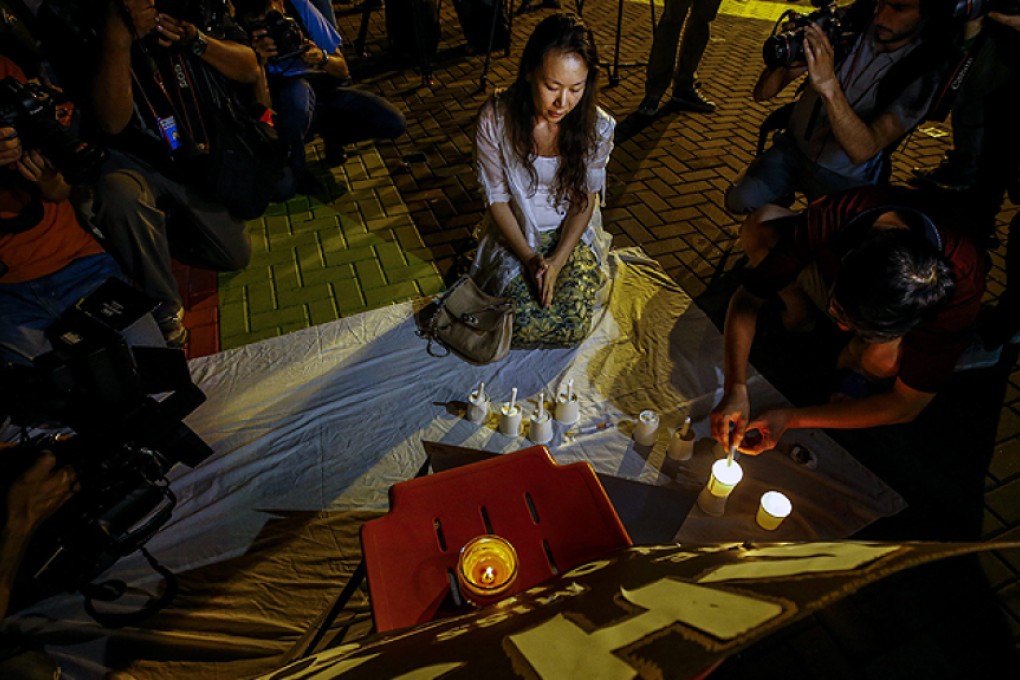 Kelly Wen, the wife of a missing MH370 passenger, attends a vigil near Kuala Lumpur ahead of the anniversary of the tragedy. Photo: Reuters