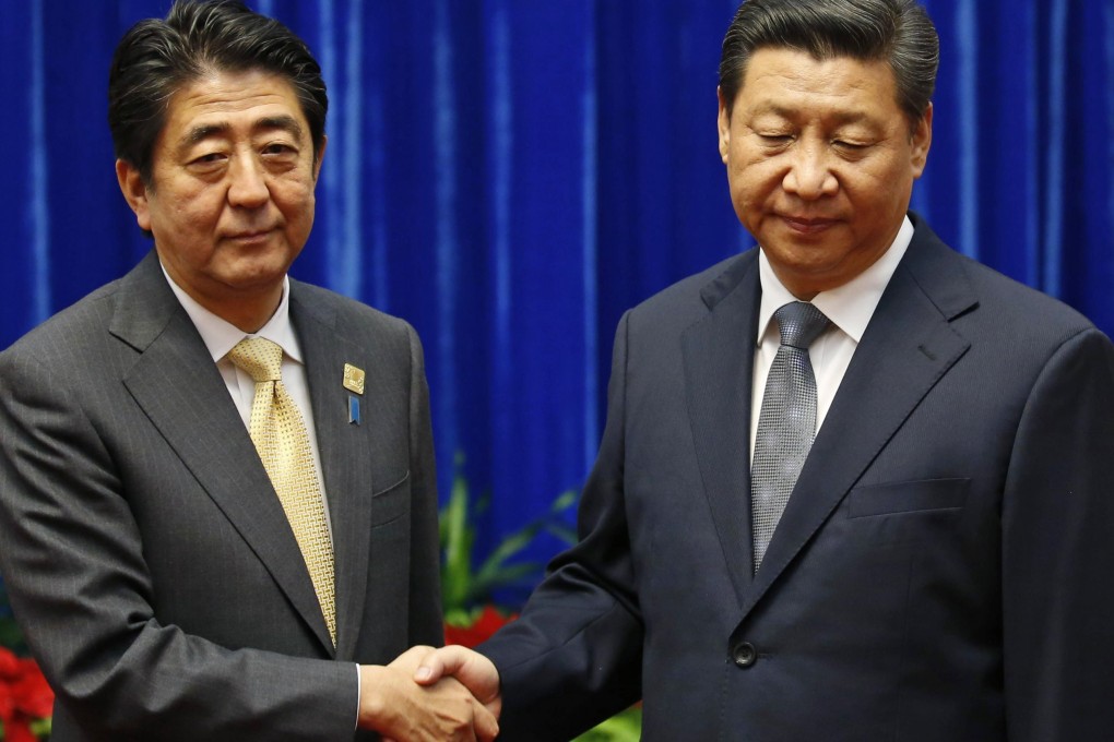 China's President Xi Jinping shaked hands with Japan's Prime Minister Shinzo Abe during their meeting at the Asia Pacific Economic Cooperation last November. Photo: Reuters