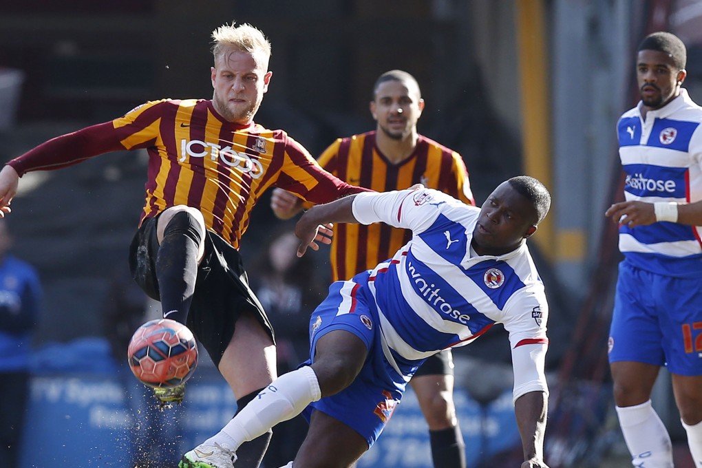 Bradford's Andrew Davies (left) vies with Reading's Yakubu for the ball. Photo: Reuters