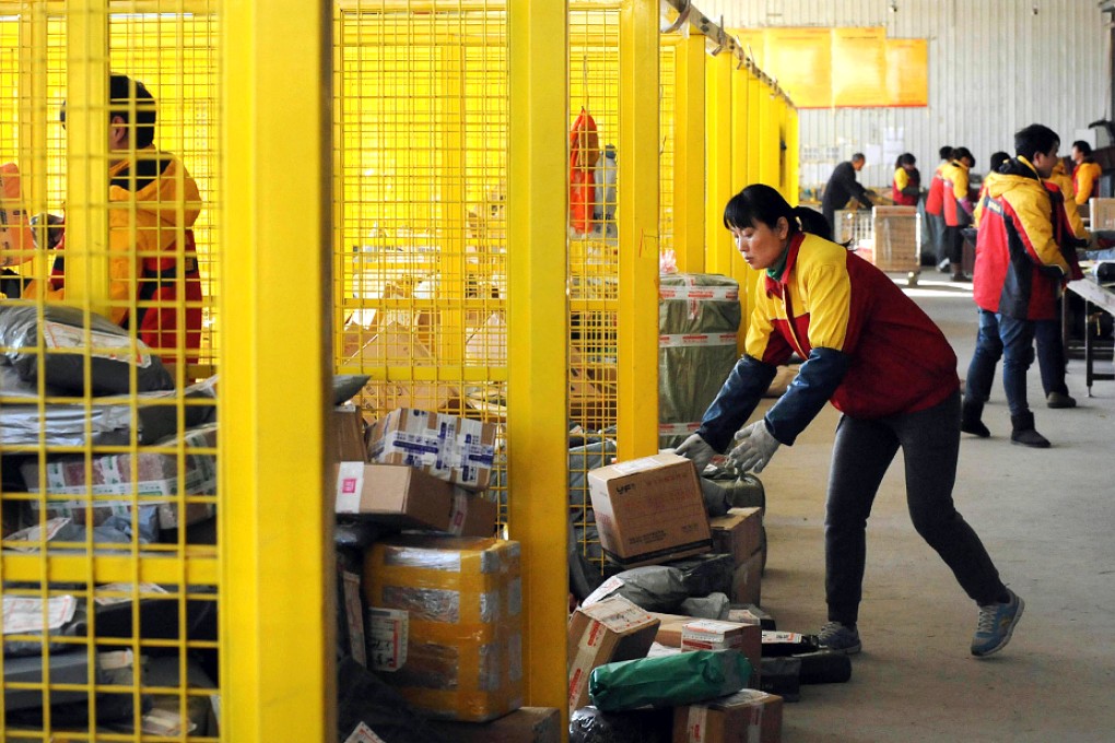 Chinese workers sort out packages meant for online shoppers at a delivery firm. Photo: AFP