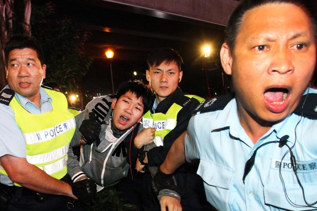 Police arrest one of the protesters who took part in the anti-parallel trading rally outside Tuen Mun MTR station. Photo: Dickson Lee