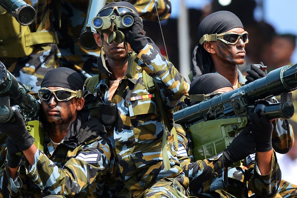 Sri Lankan army Special Force commando soldiers participate in a Victory Day parade in the southern town of Matara on May 18, 2014. The government is holding a military "victory parade" to mark five years since the defeat of Tamil Tiger rebels, who waged a decades-long battle for a separate homeland for minority Tamils. Photo: AFP