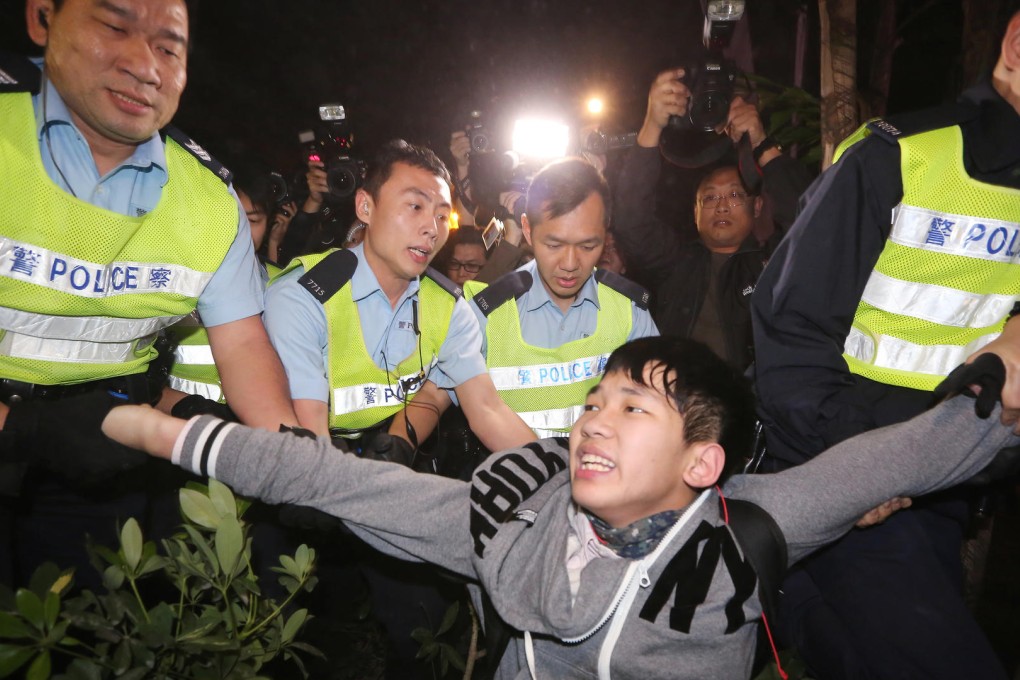 Police arrest a protester.