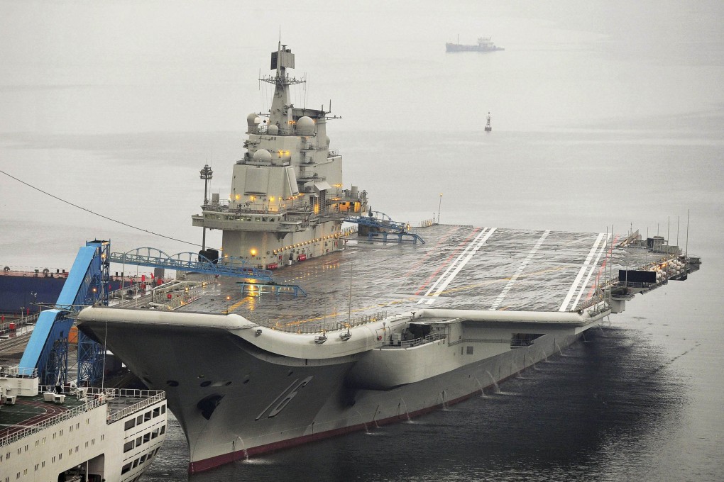 China's first aircraft carrier, Liaoning, docked at Dalian. One of the men convicted of selling state secrets took hundreds of pictures of the vessel and sent them to his employer overseas. Photo: Reuters