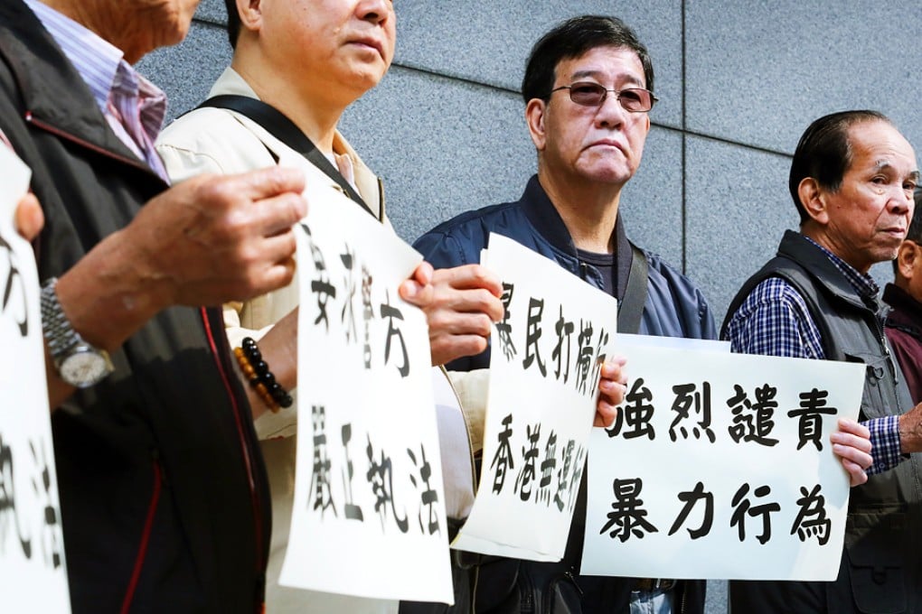 Unionists hand in a petition to Wan Chai police headquarters calling for protection of shop workers and tourists following anti-parallel trading protests that turned violent. Photo: Felix Wong