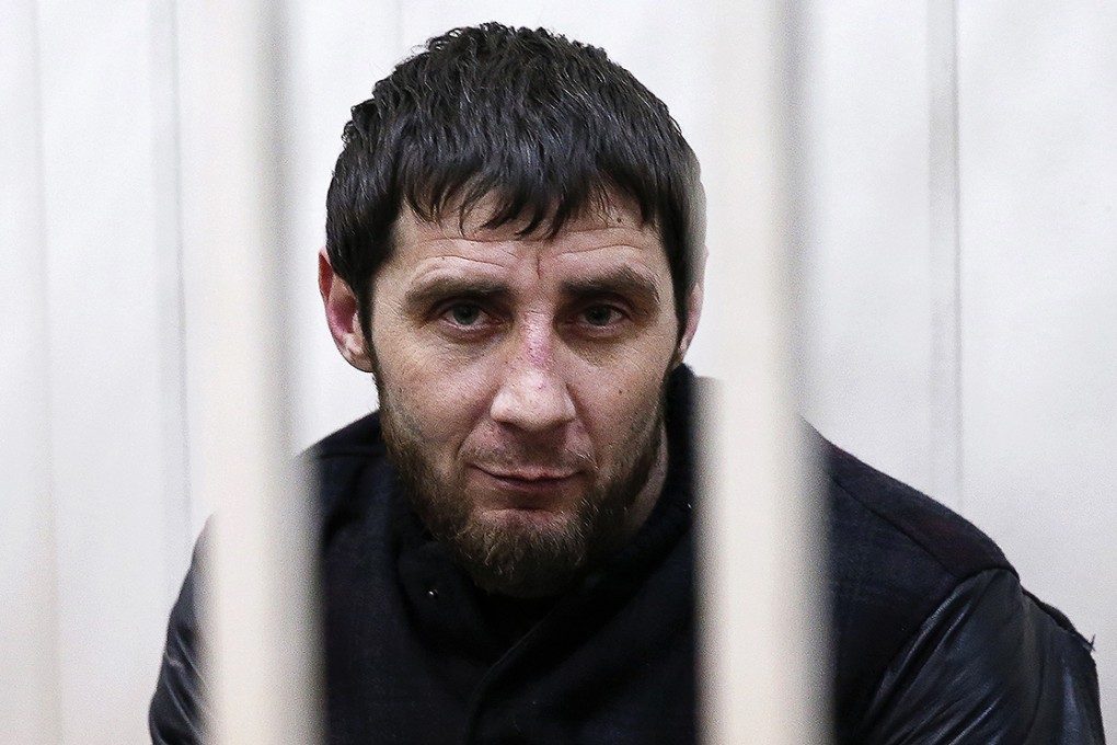 Zaur Dadayev looks out from a defendants' cage inside a court building in Moscow. Photo: Reuters