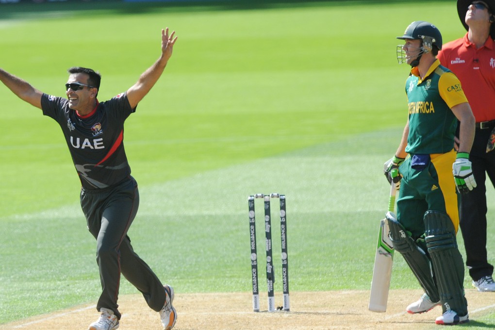 United Arab Emirates bowler Mohamed Tauqir celebrates after taking a catch to dismiss Rilee Rossouw as South African captain A.B. de Villiers watches. Photo: AP