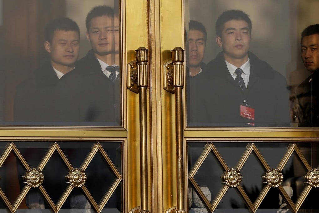 Security officers guard the entrance of the Great Hall of the People during the National People's Congress session in Beijing yesterday. Photo: EPA